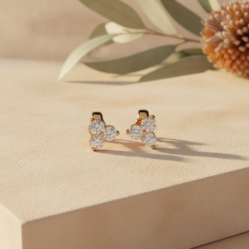 Diamond stud earrings on warm sandstone with native banksia — handcrafted in the Byron Bay Hinterland by Lucano