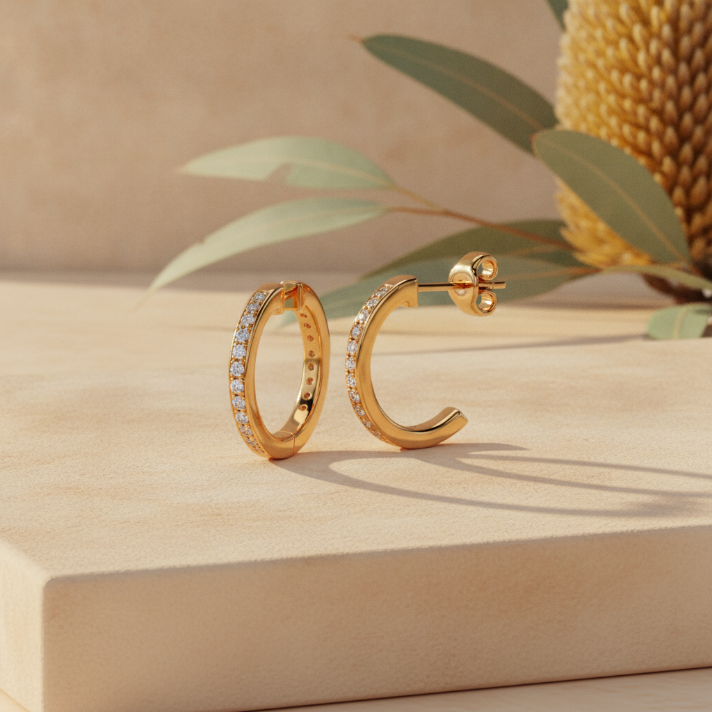 Gold diamond hoop earrings on warm sandstone with native banksia — handcrafted in the Byron Bay Hinterland by Lucano
