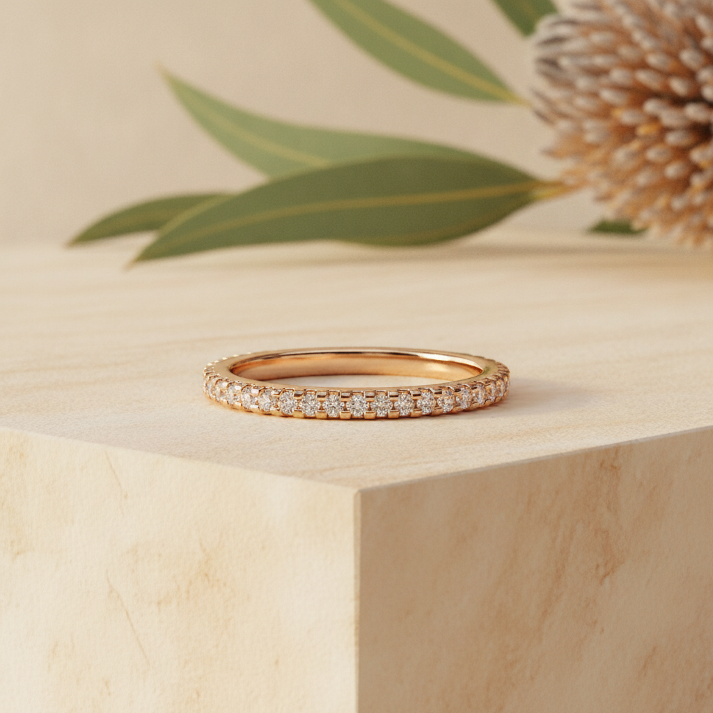 Diamond eternity ring on warm sandstone with native banksia — handcrafted in the Byron Bay Hinterland by Lucano