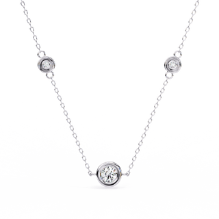 Close-up of a bezel-set diamond on the Stelle Trio gold necklace