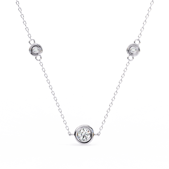 Close-up of a bezel-set diamond on the Stelle Trio gold necklace