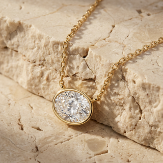 Ovalia oval diamond bezel pendant in gold, detail view