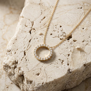 Sun diamond circle necklace worn at the collarbone