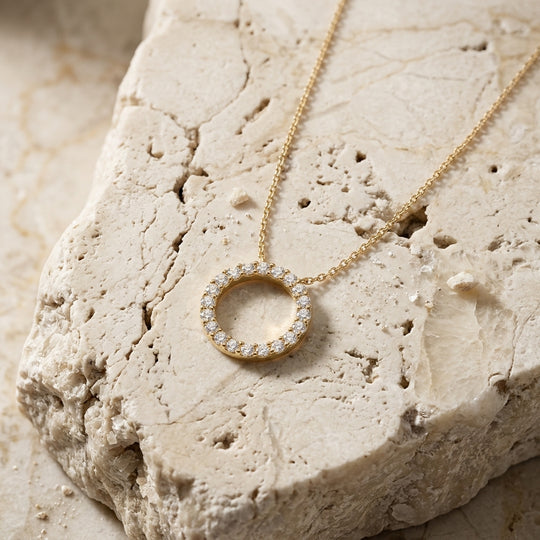 Sun diamond circle necklace worn at the collarbone