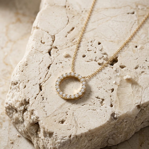 Sun diamond circle necklace worn at the collarbone