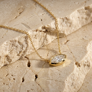 Navette marquise diamond pendant worn at the collarbone