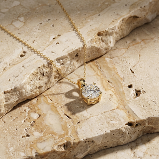 Helios diamond solitaire pendant worn at the collarbone