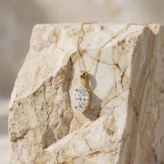 Navette marquise diamond pendant worn at the collarbone