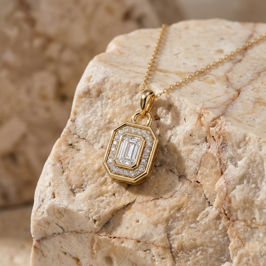 Aurelia emerald-cut diamond halo pendant in gold on a fine chain, detail view